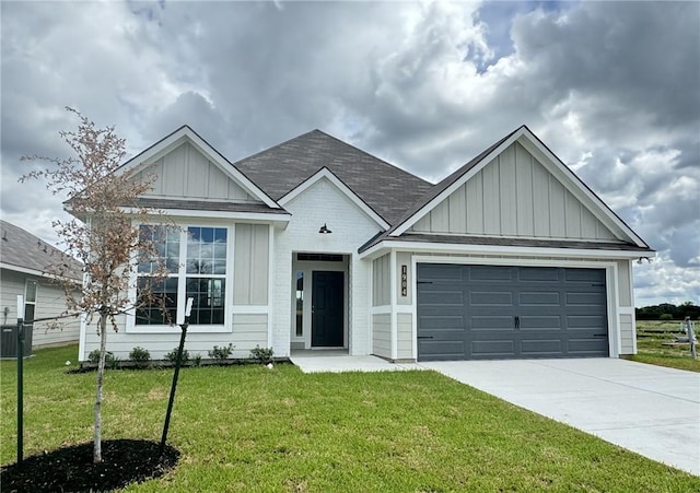 view of front of property with cooling unit, a garage, and a front yard