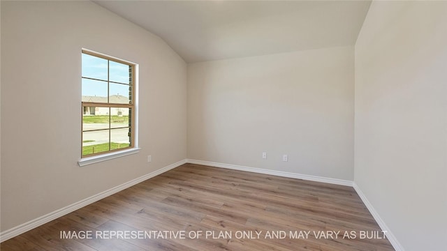 empty room with lofted ceiling and light hardwood / wood-style floors