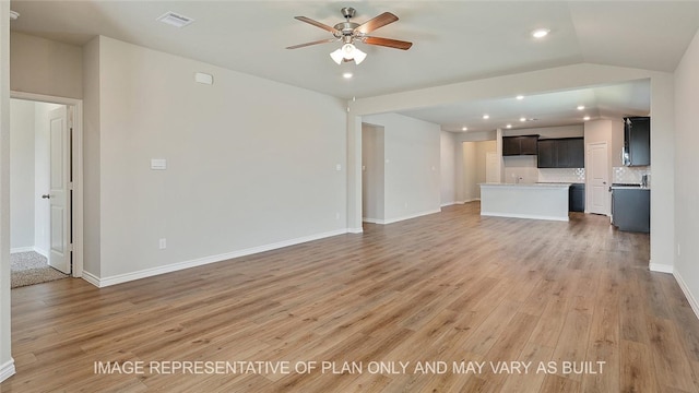 unfurnished living room with ceiling fan, hardwood / wood-style floors, and lofted ceiling