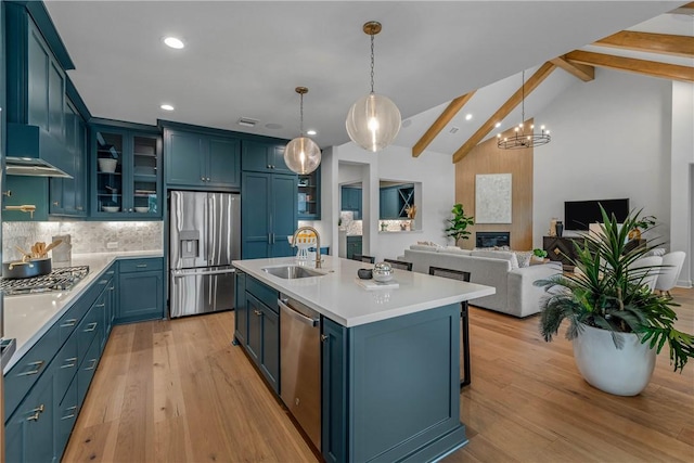 kitchen with lofted ceiling with beams, sink, blue cabinetry, and appliances with stainless steel finishes