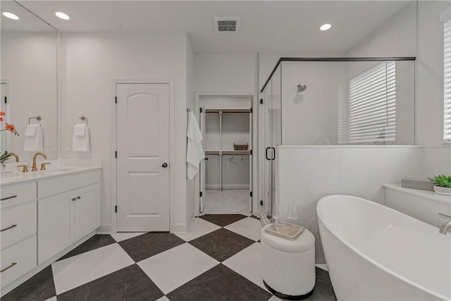 bathroom featuring vanity and shower with separate bathtub