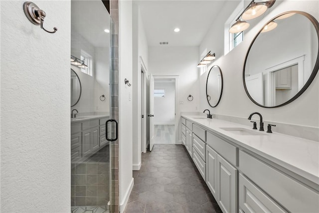 5020 Toscana Loop, Bryan, TX 77802 - bathroom featuring visible vents, a sink, and a stall shower