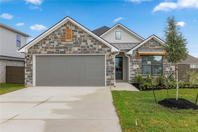 5020 Toscana Loop, Bryan, TX 77802 - craftsman-style home featuring a standing seam roof, driveway, a front yard, an attached garage, and stone siding