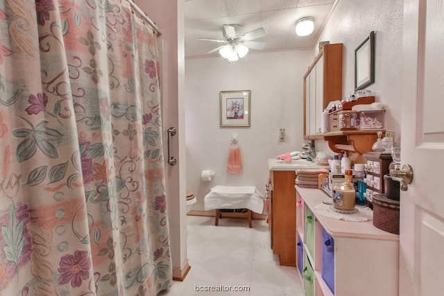 bathroom with vanity, ceiling fan, and ornamental molding