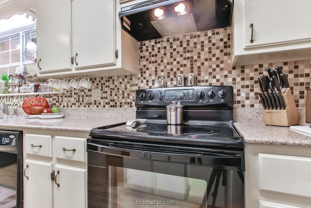 kitchen with black appliances, white cabinets, extractor fan, and tasteful backsplash