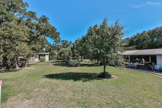 view of yard with a patio and a playground