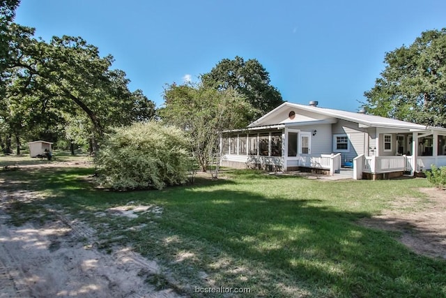 view of yard with a sunroom