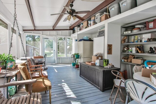 sunroom featuring ceiling fan and lofted ceiling with beams