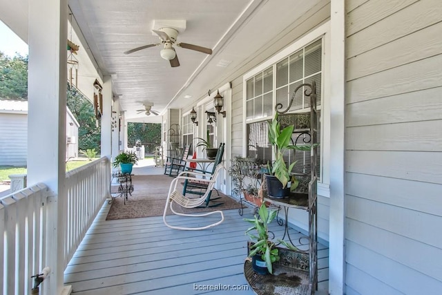 wooden deck featuring covered porch and ceiling fan