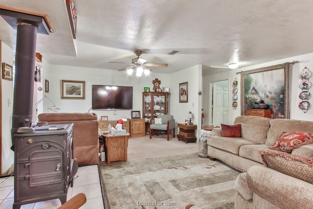 carpeted living room with ceiling fan and a textured ceiling