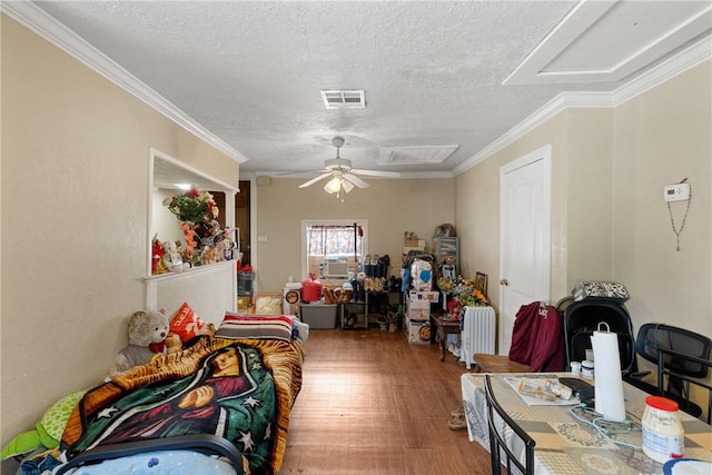 interior space with ceiling fan, crown molding, and a textured ceiling