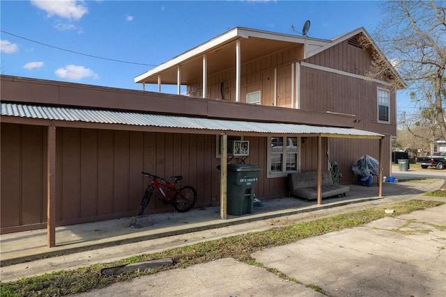 rear view of property featuring a balcony