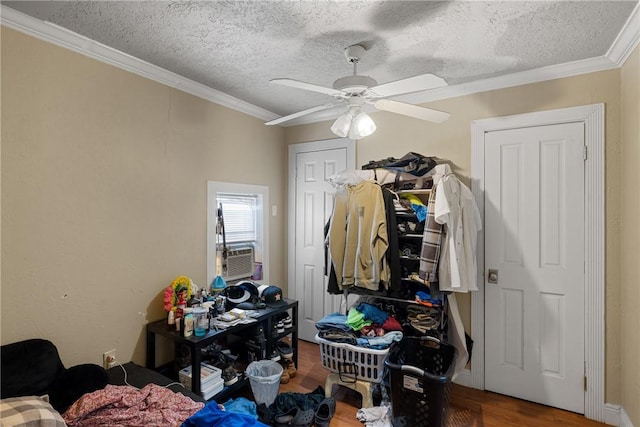 bedroom featuring ceiling fan, wood-type flooring, crown molding, cooling unit, and a textured ceiling