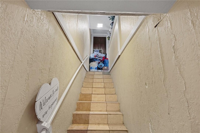 stairway featuring tile patterned flooring