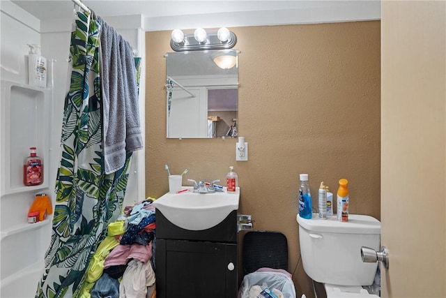 bathroom with toilet and vanity