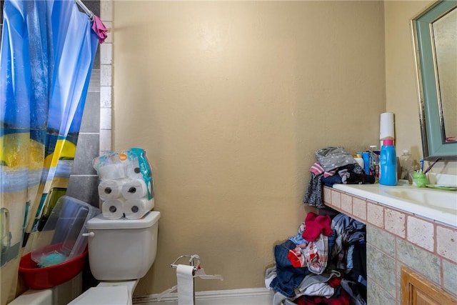 bathroom featuring toilet and sink