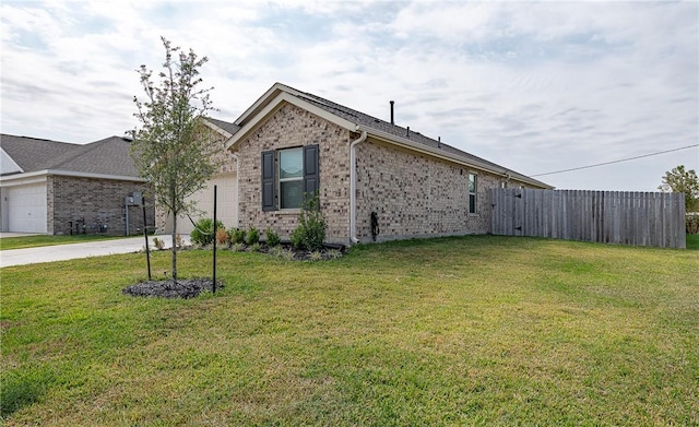 view of property exterior with a lawn and a garage