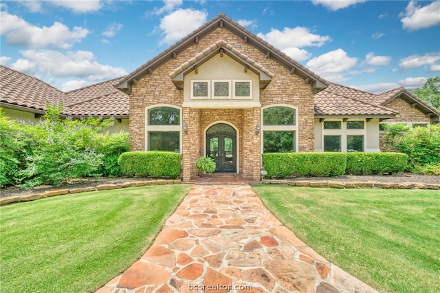 view of front of house featuring french doors and a front yard