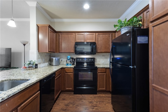 kitchen featuring black appliances, decorative light fixtures, dark hardwood / wood-style flooring, and crown molding