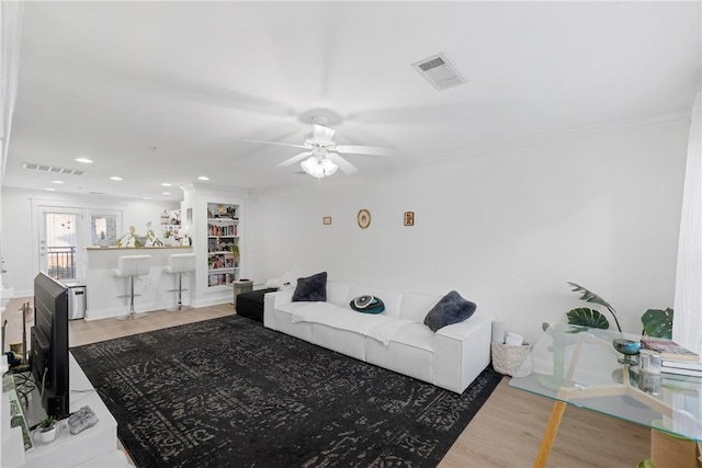 living room with recessed lighting, visible vents, wood finished floors, and a ceiling fan