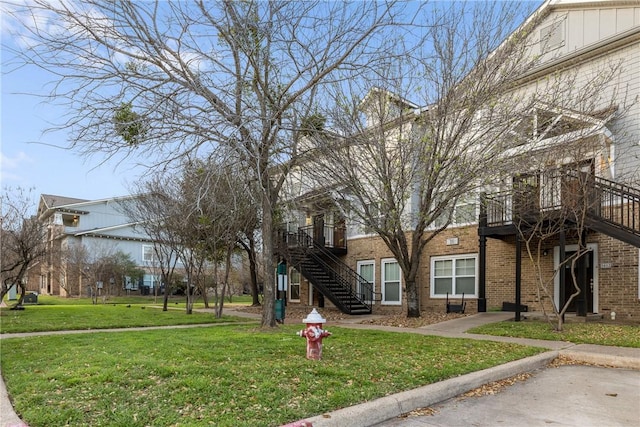 surrounding community featuring stairway and a yard