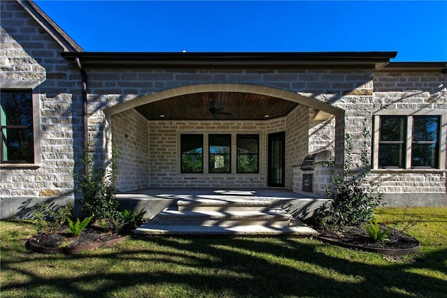 property entrance featuring covered porch and a yard