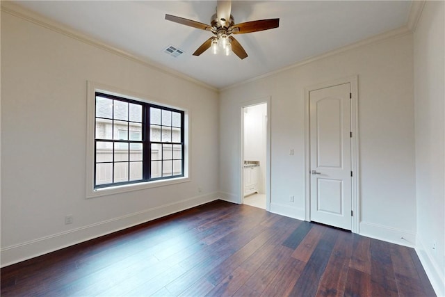 unfurnished bedroom with connected bathroom, ceiling fan, crown molding, and dark wood-type flooring