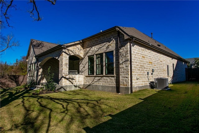 view of property exterior featuring a yard and central AC