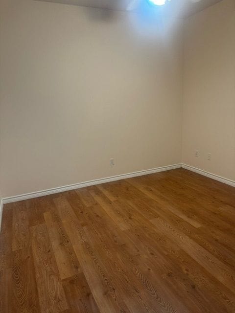 spare room with hardwood / wood-style floors