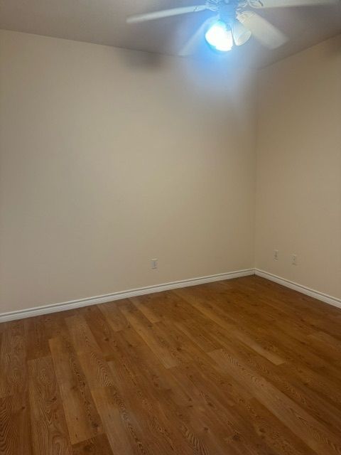 spare room with hardwood / wood-style floors