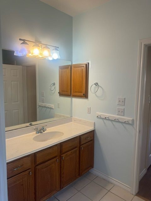 bathroom with tile patterned flooring and vanity