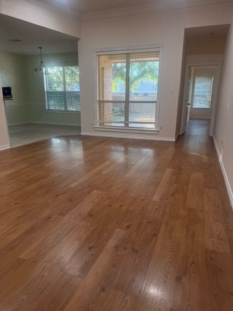 interior space featuring a chandelier, crown molding, and wood-type flooring