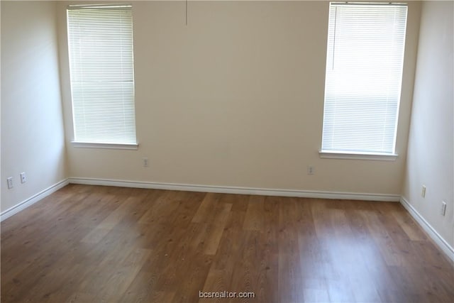 empty room with hardwood / wood-style flooring