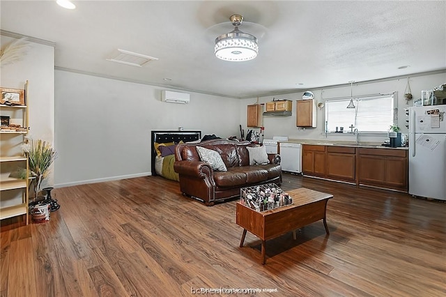 living room with ornamental molding, a textured ceiling, dark wood-type flooring, sink, and an AC wall unit