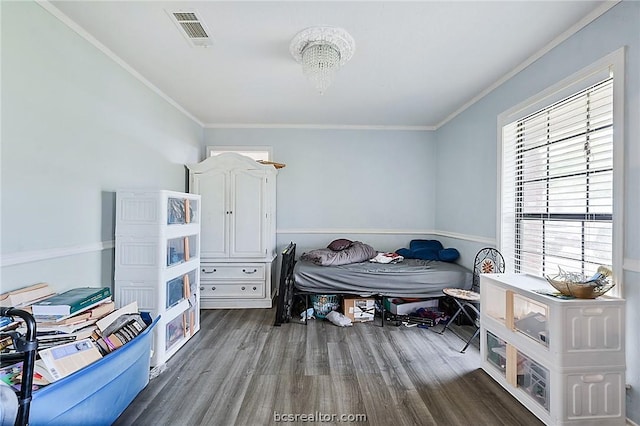 bedroom featuring dark hardwood / wood-style flooring, multiple windows, and ornamental molding