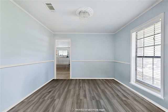 empty room featuring crown molding, a healthy amount of sunlight, and dark hardwood / wood-style floors