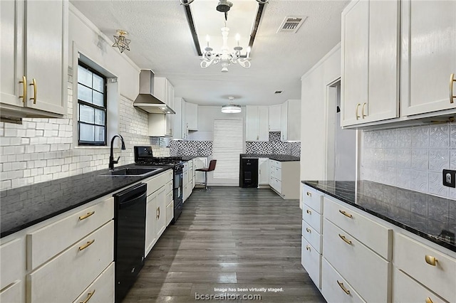 kitchen with white cabinetry, sink, wall chimney exhaust hood, and pendant lighting