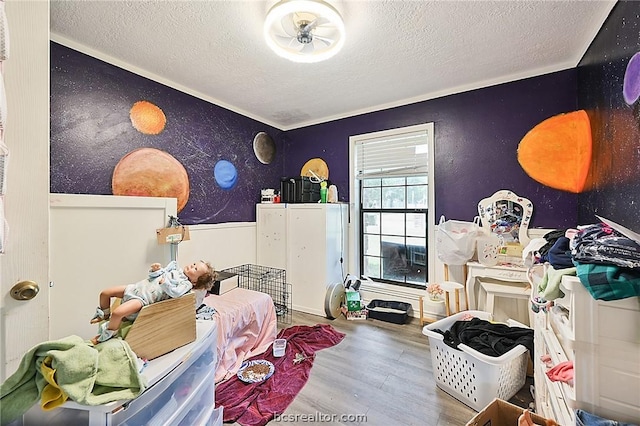 bedroom featuring hardwood / wood-style flooring and a textured ceiling