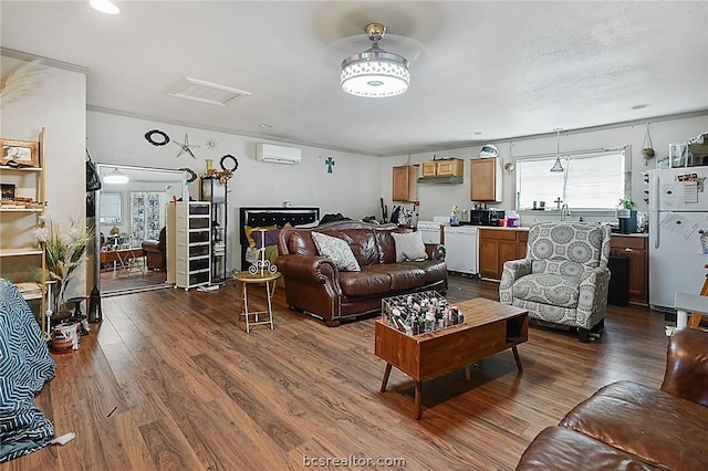 living room with ceiling fan, dark hardwood / wood-style flooring, a wall mounted air conditioner, and sink