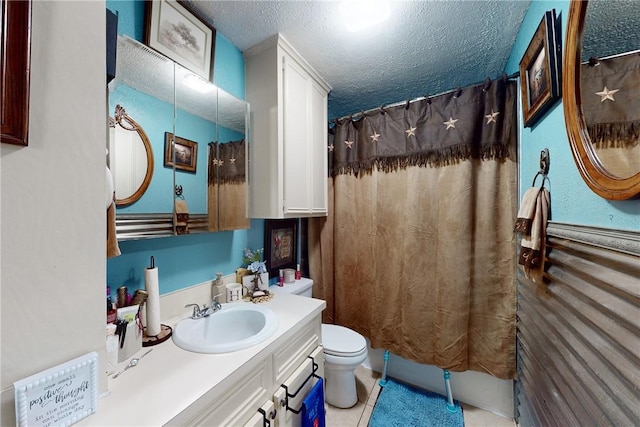 full bathroom with curtained shower, toilet, a textured ceiling, vanity, and tile patterned floors