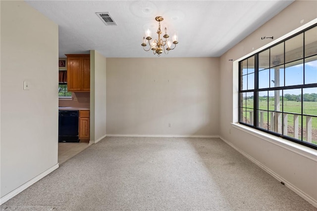 unfurnished dining area featuring a chandelier, baseboards, visible vents, and light colored carpet