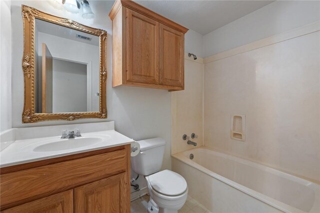 bathroom with toilet, vanity, washtub / shower combination, and visible vents