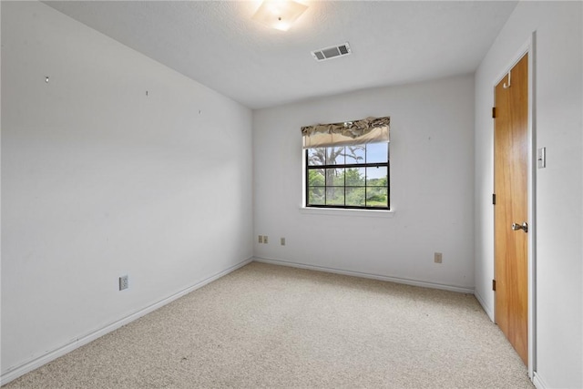 unfurnished room with light carpet, baseboards, and visible vents