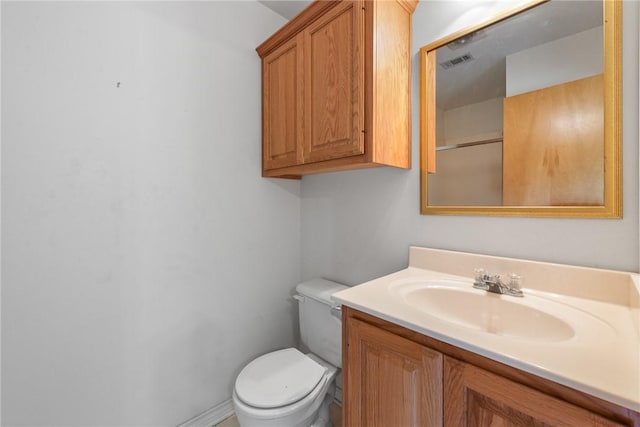 bathroom with visible vents, toilet, and vanity