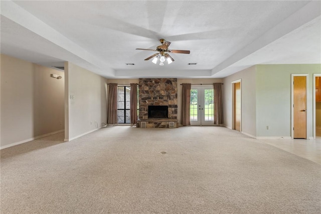 unfurnished living room with ceiling fan, baseboards, a healthy amount of sunlight, and a fireplace