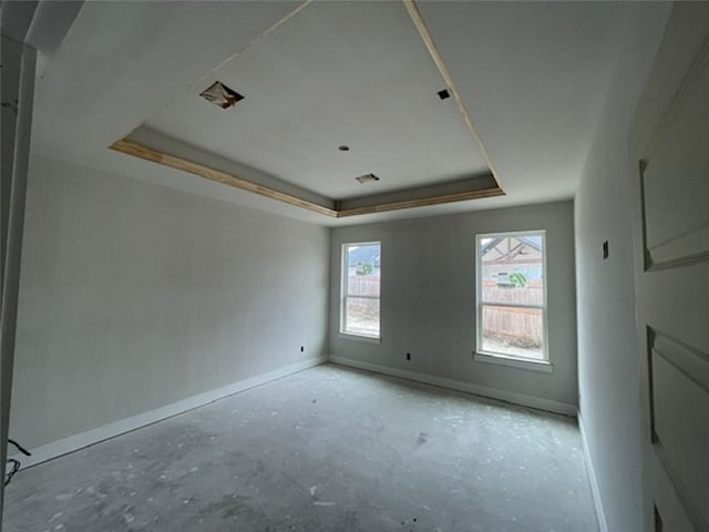 unfurnished room with a raised ceiling