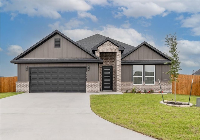 2916 Bombay Ct, Bryan, TX 77808 - view of front of house with brick siding, an attached garage, concrete driveway, a shingled roof, and board and batten siding