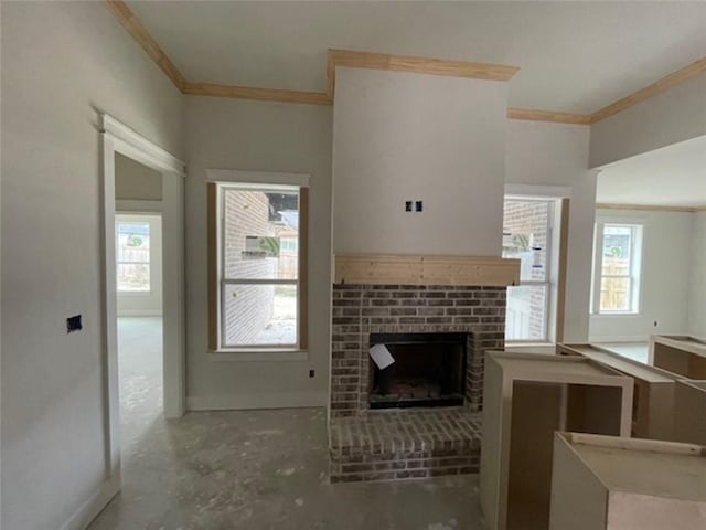 unfurnished living room featuring crown molding, plenty of natural light, and a fireplace