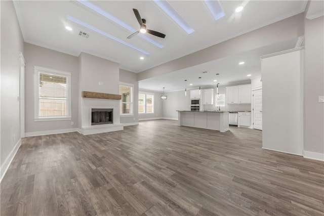2916 Bombay Ct, Bryan, TX 77808 - unfurnished living room with ceiling fan, dark wood-style floors, baseboards, recessed lighting, and ornamental molding