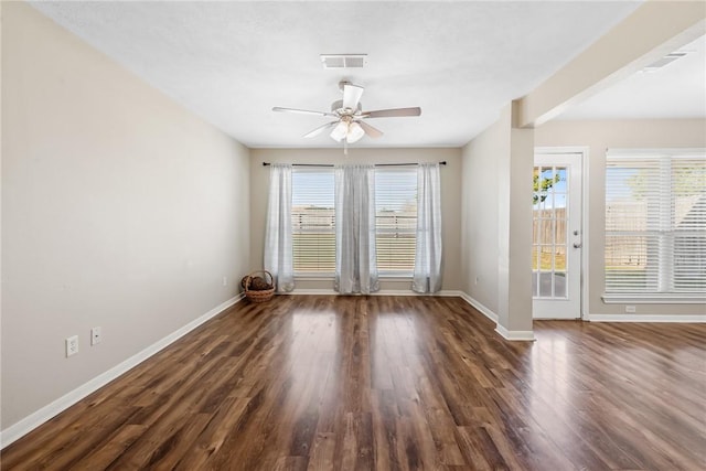 empty room with dark hardwood / wood-style flooring and ceiling fan